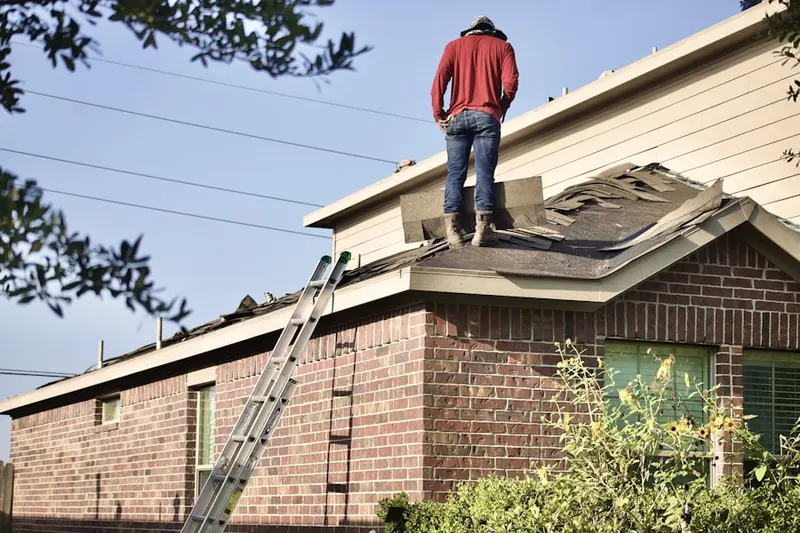 Professional roofer working on a residential roof in Hackensack River Waterfront